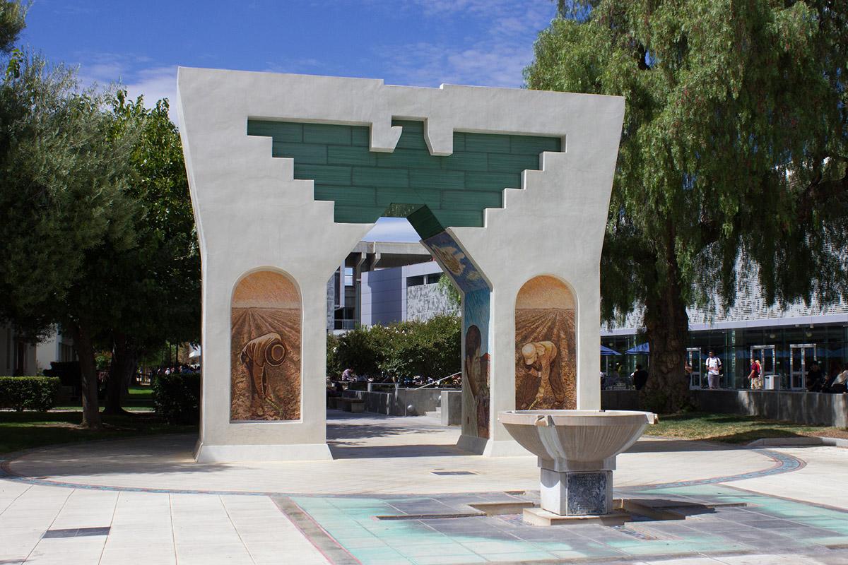 Cesar Chavez arch with farm workers in mosaic tile on each pillar.